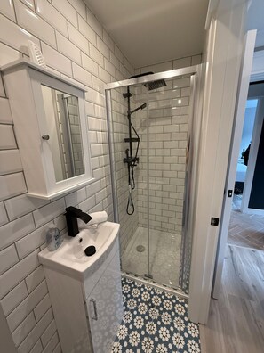 Regadera, toallas, papel de baño 