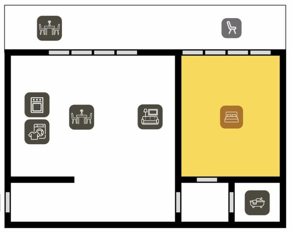 Distribución de un hotel que incluye un comedor, una habitación con cama, un baño y una zona de lavandería.
