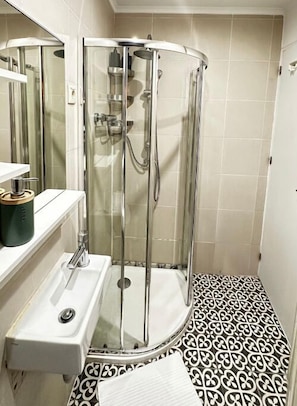 Shower, hair dryer, towels, toilet paper
