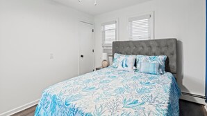 A bedroom with a bed, a ceiling fan, and a window with blinds. - Cozy 2 Bedroom with a view with WiFi, AC (Seaside Heights)