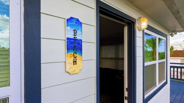 A house with a porch, a door, and a sign that reads "Beach House". - Newly Updated Walk to Beach & Ocean Center (Daytona Beach)