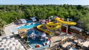 A resort with a large pool, water slides, and a beach area. - Mobile Home Caravan with Shared Pool and Private Terrace (Unknown)