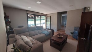 Un salon moderne avec un canapé, une table basse et une cheminée.