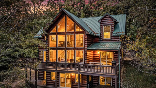 A log cabin with multiple windows, a balcony, and a small attached structure. - Lakefront Mountain Retreat on Watauga Lake (Butler)