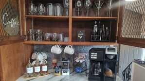 A kitchen with a coffee machine, tea and sugar containers, and a coffee grinder. - 2-bedroom House in beautiful Grand Island,NY! 4 miles from Niagara Falls! (Grand island)