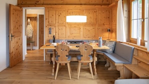 A wooden interior with a dining table, chairs, and a bench. - La Siala Apt.54 by Interhome (Falera)
