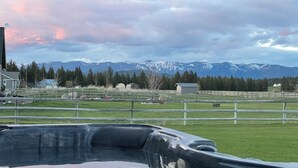 A view of a fenced pasture with a mountain range in the background. - New! Home on one acre, dog friendly, private hot tub (Kalispell)