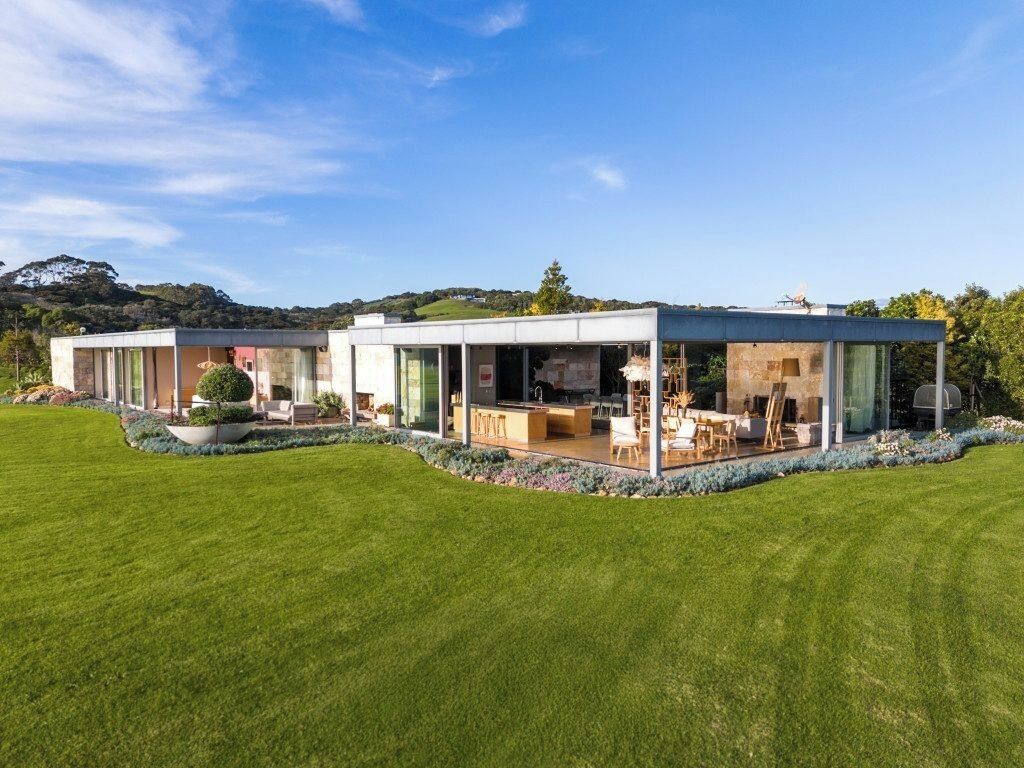 A modern house with a spacious outdoor area, a dining area, and a kitchen.