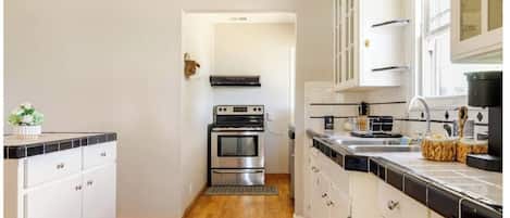 Fridge, stovetop, dishwasher, coffee/tea maker