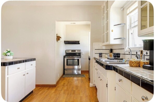 Fridge, stovetop, dishwasher, coffee/tea maker