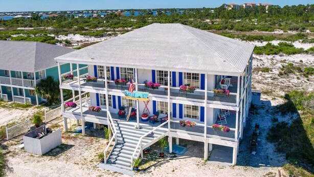 A multi-story hotel with balconies, a staircase, and a beach view. - Deck + Gulf of America View: `Sunrise` on Perdido Key! (Pensacola)