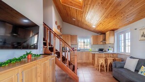 A spacious kitchen with wooden cabinets, a built-in stove, and a large window.