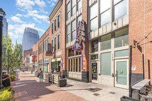 A street with brick buildings, a Taco Bell, and a building with a large glass window.