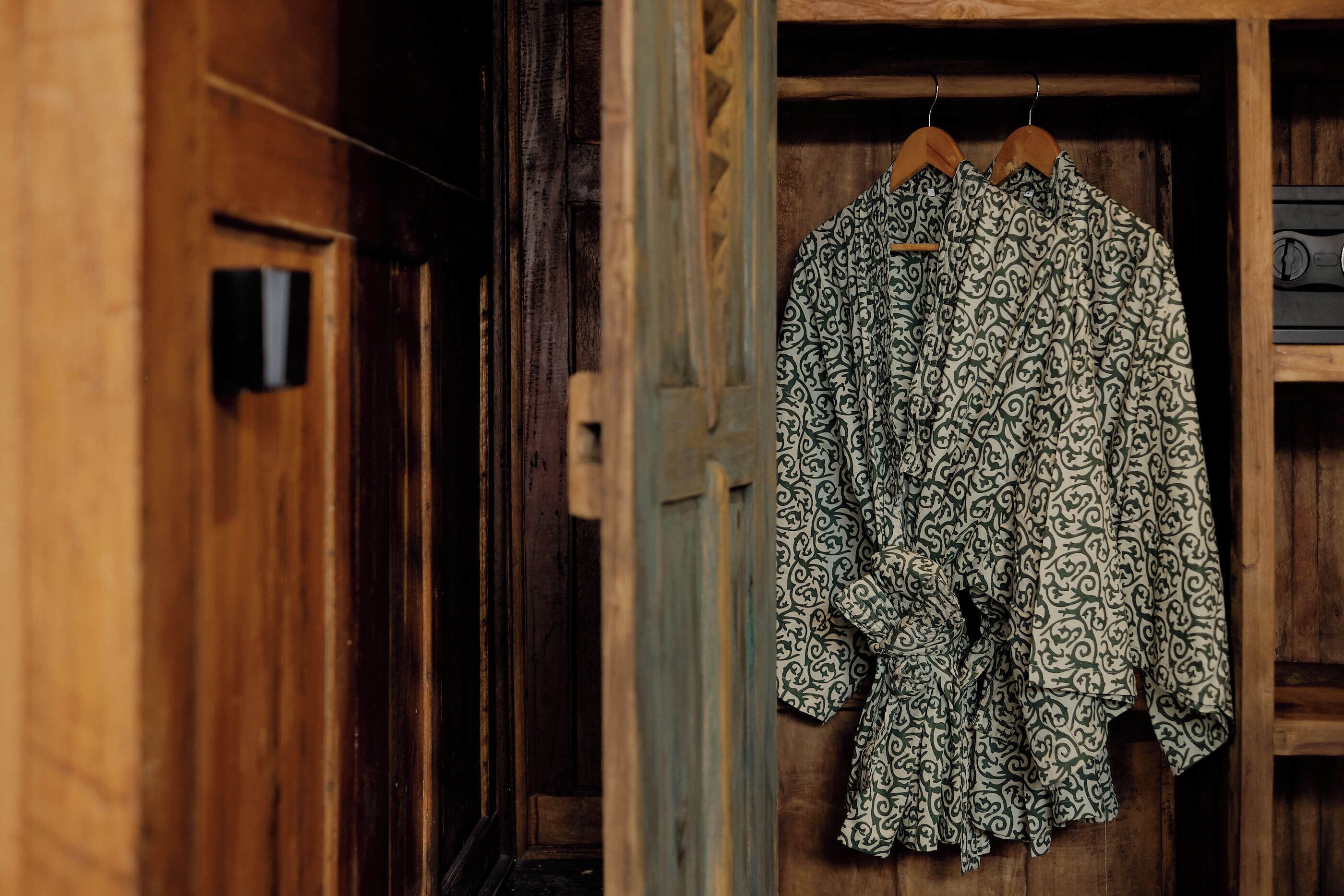 A wooden door with a hanging garment.