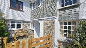 A traditional stone house with white walls and multiple windows. - Myrtle Cottage - sleeps 4 guests  in 2 bedrooms (St Mawes)