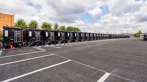 A row of black train cars parked in a parking lot with white lines on the ground. - HOTEL R9 The Yard Mokaaramachi (Mooka)