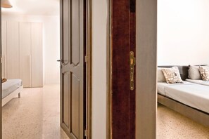 A room with a bed, a sofa, and a wardrobe.