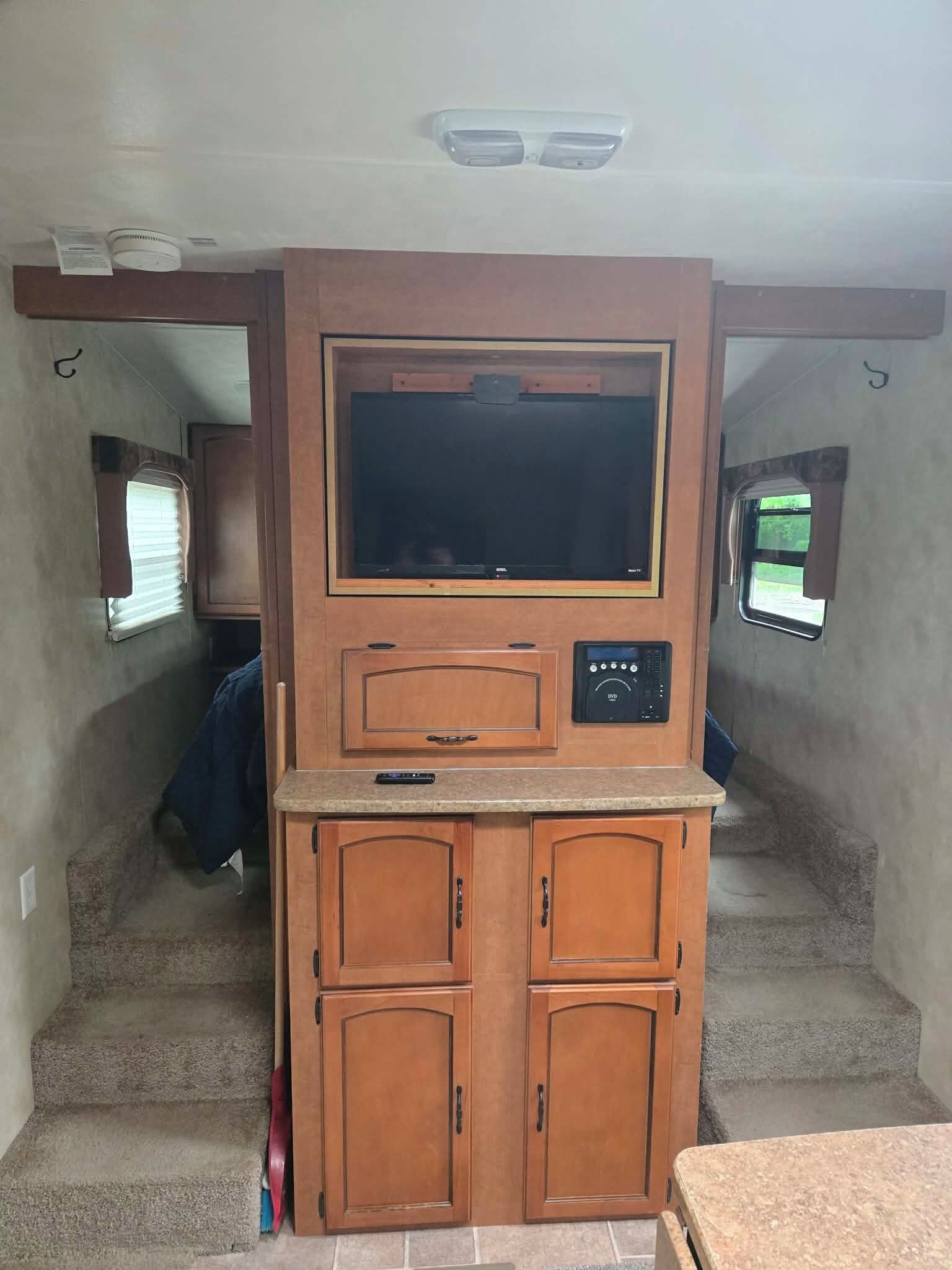 A compact kitchenette with a built-in oven, microwave, and a small countertop.