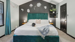 A neatly arranged bedroom with a bed, bedside lamps, a headboard, a window with curtains, and a door. - Near AtL, Pickleball, Golf, Pool, Karaoke, Tikibar, 1.25 Acre Private Retreat (Locust Grove)