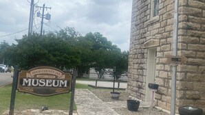 En bygning af sten med et skilt, der siger "HOOD COUNTY JAIL 1885-1978 MUSEUM".