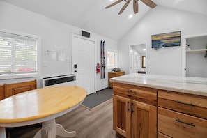 Enjoy meals in the kitchen with a dining table and cabinets.
