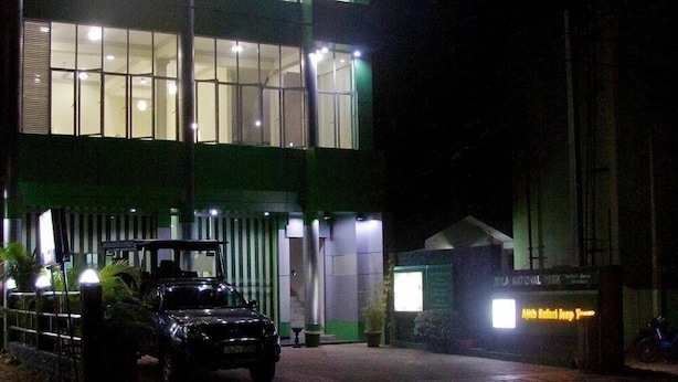 A multi-story building with illuminated windows and a sign for Yala National Park. - Ajith Safari Lodge (Tissamaharama)