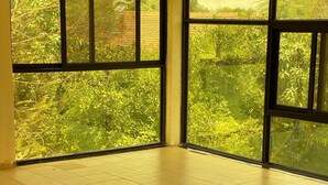 A spacious room with large windows, a tiled floor, and a beige sofa. - Charming 3-bedroom villa with Wifi, AC in lovely Somone near Saly. (Somone)