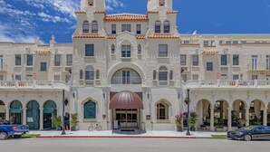 A large, historic building with a symmetrical facade, multiple windows, and a central entrance with a brown awning. - Palm Beach Condo, Poolside Gem! Walk to Beach (Palm Beach)