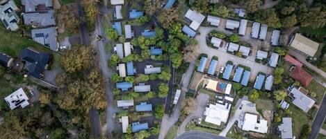 Luchtbeeld van een woonwijk met vrijstaande huizen, wegen en groene ruimtes.