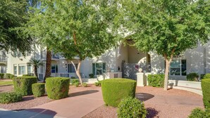 A landscaped courtyard with neatly trimmed hedges, a palm tree, and a building with a sign reading "1st Street". - 1 Mi to Tempe Beach Park: Well-Equipped Condo! (Tempe)