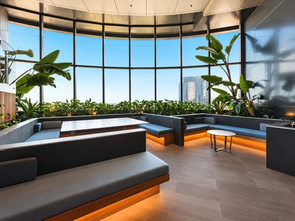 A modern interior with seating areas, large windows, and indoor plants.