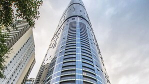 A tall, modern hotel with a curved entrance and a prominent address sign. - 12- Comfy 2B in the Heart of CBD (Brisbane City)