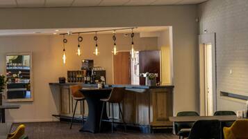 Enjoy a stylish space with a bar area, dining table, and comfortable seating.
