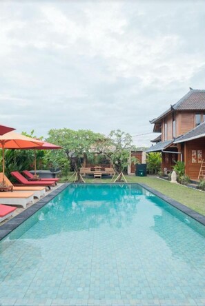 Relax by the serene pool surrounded by lush gardens and comfortable lounge chairs.