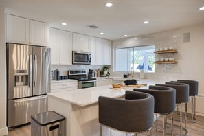 Fridge, stovetop, dishwasher, coffee/tea maker