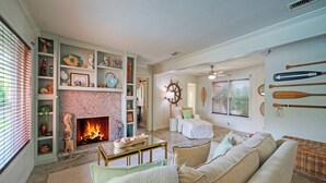 A living room with a fireplace, a sofa, and a collection of decorative items.