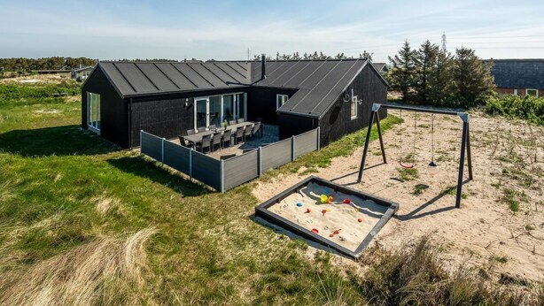 A modern house with a patio, a swing set, and a sandbox. - "Agnes" - 900m from the sea by Interhome (Ringkøbing)