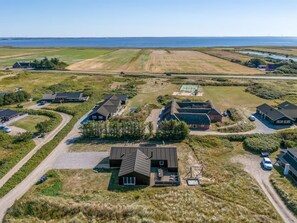 An aerial view of a residential area with houses, roads, and a body of water in the background. - "Agnes" - 900m from the sea by Interhome (Ringkøbing)