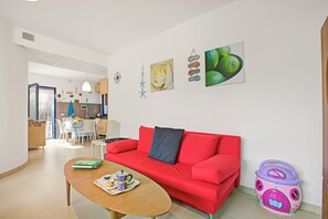 Family Villa, Multiple Bedrooms (Villetta Pino Pool And Sea) | Living area | 21-inch TV with cable channels