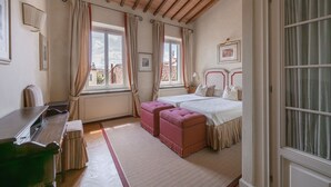 A bedroom with two beds, a desk, and a window with curtains. - Duomo View Terrace By Belcanto Villas (Florence)