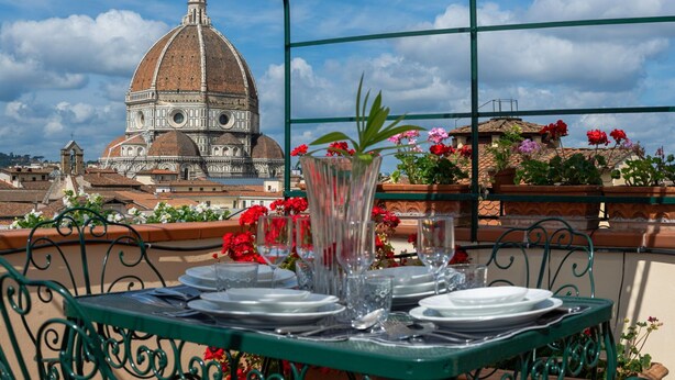 A table set for dining with a view of the Florence Cathedral. - Duomo View Terrace By Belcanto Villas (Florence)
