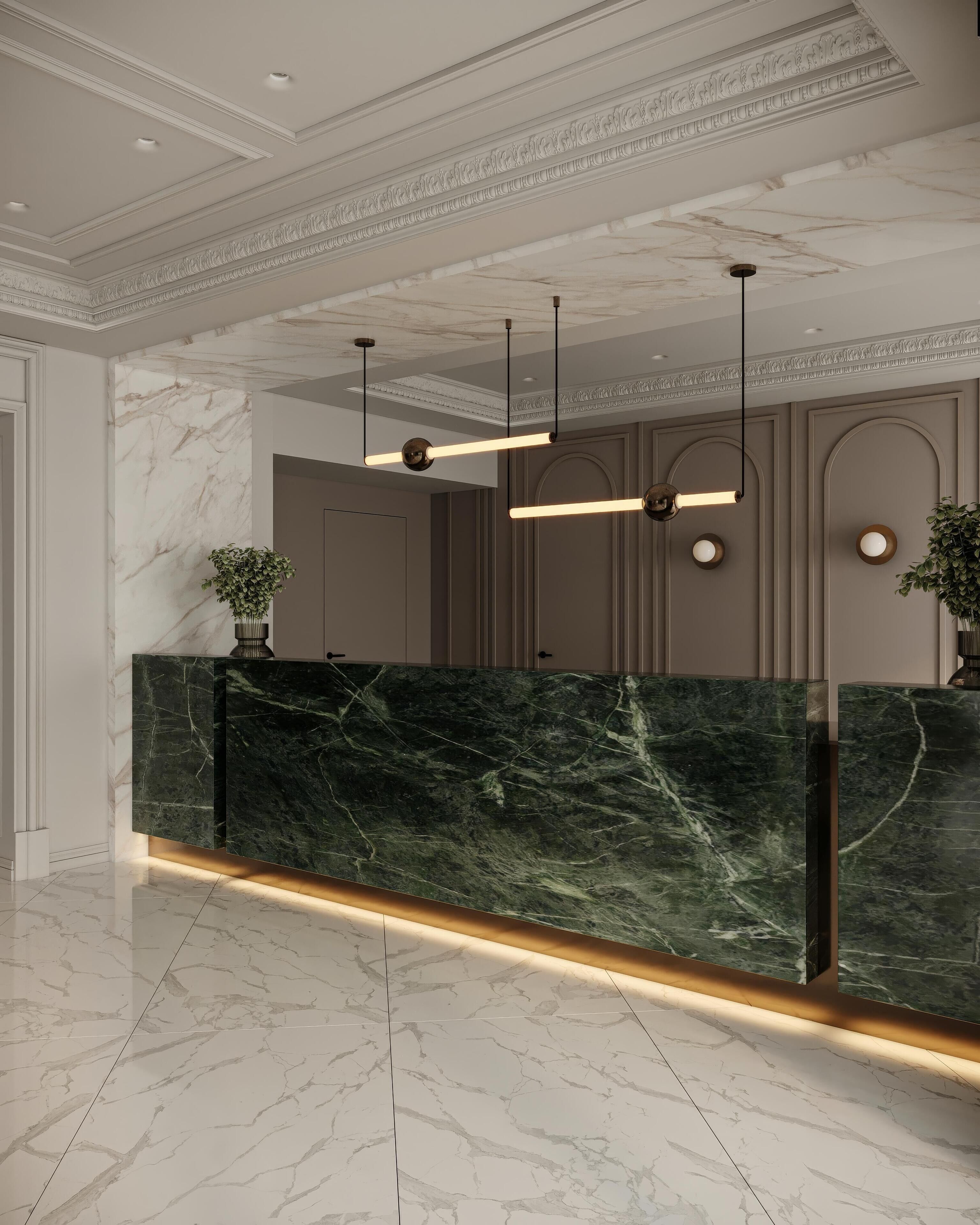 A reception area with a marble counter, pendant lighting, and a plant.