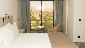 Deluxe Double or Twin Room, City View | In-room safe, desk, laptop workspace, blackout drapes