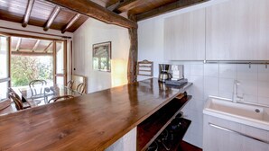 A kitchen with a wooden countertop, a coffee maker, and a sink. - Villa Maria with private pool (Moniga del Garda)