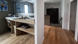 A modern bathroom with a large mirror, two sinks, wooden shelves, and a wooden floor. - Villa with swimming pool, very quiet, near Cannes/Juans les pins (Vallauris)