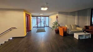 A spacious living area with a staircase, a potted plant, and a sofa. - Vacation in the vacation apartment Morgenröte with sauna and terrace centrally located in Mirow (Mirow)