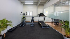 A gym with treadmills, dumbbells, and weight machines. - Housr 43 Gachibowli Near DLF Cybercity (Hyderabad)