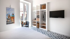 A bedroom with a bed, a TV, a window, a chair, and a wardrobe. - Ci Capo 3 by Wonderful Italy (Palermo)