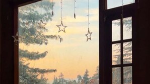 Una habitación con un ventanal grande que da a un área boscosa.