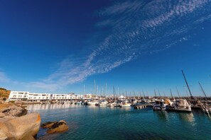 Stunning waterfront marina with boats docked along the shore.
